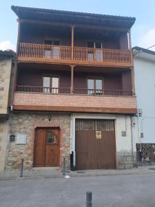 an apartment building with a balcony and two doors at Casa Salamó in Ampuero