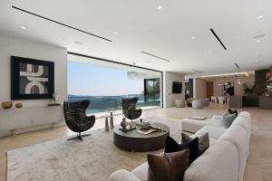 a living room with a couch and a table and chairs at Stradella Como in Beverly Glen