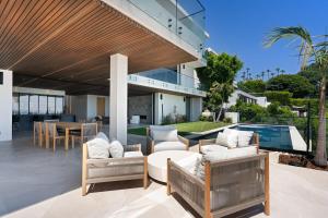 an outdoor patio with furniture and a swimming pool at Stradella Como in Beverly Glen