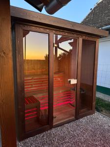 a glass room with a view of the sunset at Horizont Haus in Tevel