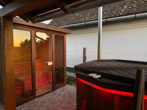 a hot tub sitting outside of a house at Horizont Haus in Tevel