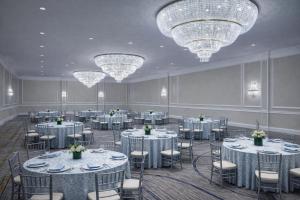 a banquet hall with tables and chairs and chandeliers at The Westin Mount Laurel in Mount Laurel +13 photos