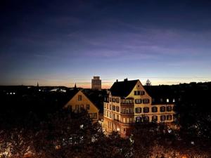 a view of a building in a city at dusk at Stylish Apartment Balcony 2 BR Central in Kaiserslautern
