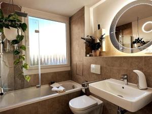 a bathroom with a sink and a toilet and a tub at Stylish Apartment Balcony 2 BR Central in Kaiserslautern +60 photos