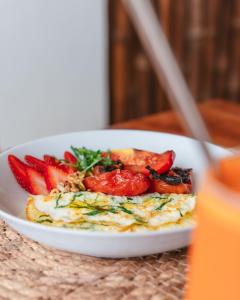 a plate of food with strawberries on a table at Laola Surf Residence in El Sunzal