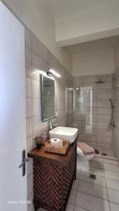a bathroom with a sink and a toilet at Trousas Apartments in Roda +47 photos