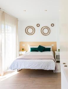 a bedroom with a bed with two mirrors on the wall at Villa Paula Trinidad in Salou