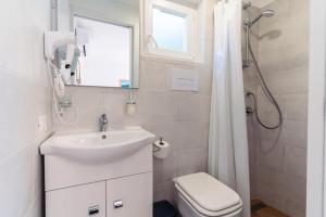 a bathroom with a sink and a toilet and a shower at B&B Morrocoy Beach in Marina di Camerota