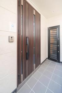 a door in a room with a phone on the wall at the UNIT5 HOUSE Roppongi in Tokyo