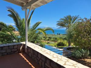 a view of the ocean from the patio of a house at The Iconpainter Zaga Villa in Kómboi