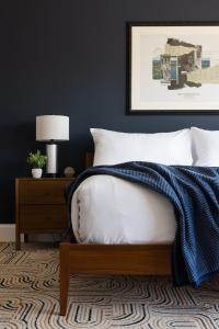 a bedroom with a bed and a nightstand with a lamp at The Courier Hotel in Salem