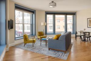 a living room with a couch and chairs and a table at The Courier Hotel in Salem