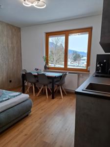 a kitchen with a table and chairs in a room at FEWO Erika in Presseggen