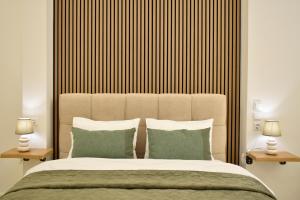 ein Schlafzimmer mit einem großen Bett und zwei Lampen in der Unterkunft Chatzidakeio View Apartments in Xánthi