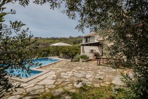 an external view of a house with a swimming pool at Refugio Ivanini in Zagorje
