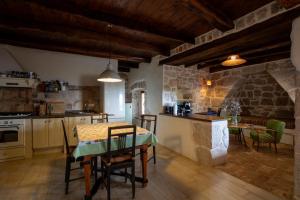 a kitchen and dining room with a table and chairs at Refugio Ivanini in Zagorje