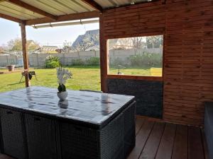 a table with a vase on it on a patio at maison de vacances gite duplex in Erquy