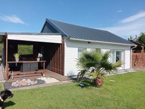 a white shed with a table in a yard at maison de vacances gite duplex in Erquy