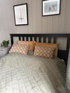 a bed in a bedroom with two pictures on the wall at Mountain apartment in Vaga +1 photo
