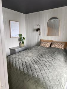 a bedroom with a bed and a table and a mirror at Mountain apartment in Vaga