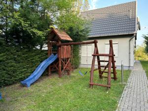 a playground with a slide and a play structure at ReZa111 in Békésszentandrás