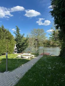a park with a lake and a picnic table and a pond at ReZa111 in Békésszentandrás