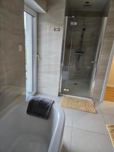 a bathroom with a bath tub and a shower at Harmonia in Radochów +19 photos