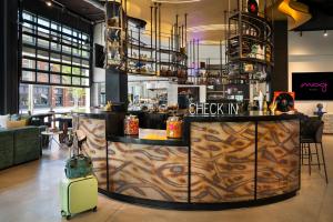 a restaurant with a bar with a suitcase at Moxy Atlanta Downtown in Atlanta +113 photos