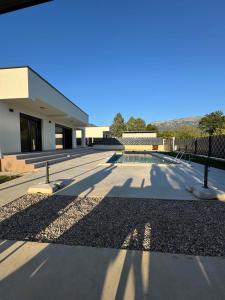 a building with a patio and a pool at Villa Vento Mostar in Mostar