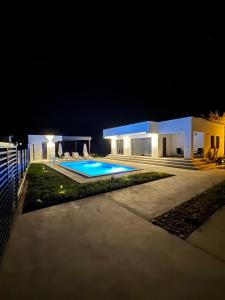 a house with a swimming pool at night at Villa Vento Mostar in Mostar
