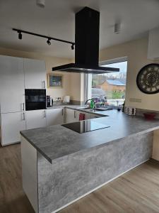 a kitchen with a large gray counter top in a room at Harmonia in Radochów