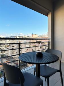 a table and chairs on a balcony with a view at DuoNest-BoHo Sunset in Tirana