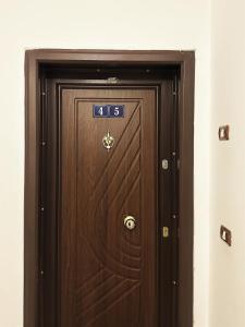 a wooden door with the number on it at DuoNest-BoHo Sunset in Tirana