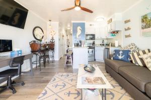 a living room and kitchen with a couch and a table at Casa Del Mar 231 - Ocean View Family Retreat on Seawall in Galveston