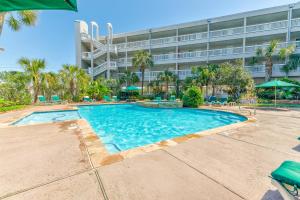a swimming pool in front of a building at Casa Del Mar 231 - Ocean View Family Retreat on Seawall in Galveston