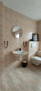 a bathroom with a sink and a toilet at Isabella in Weißwasser +15 photos