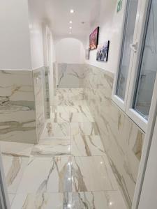 a bathroom with a marble floor and a window at Hotel Eurorooms in Rome +40 photos