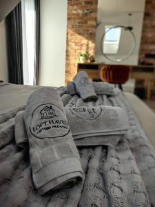 a pile of towels sitting on top of a bed at Loft Haven - Loftowa Przystań in Trzemeszno +127 photos