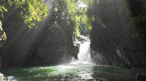 a waterfall in the middle of a river at Casa Morpho, Modern Studio with Unique Waterfall Views in Barú