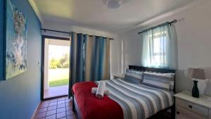 a bedroom with a bed with a towel on it at Shelley Point Townhouse in Stompneusbaai