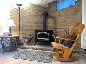 a room with a brick wall with a wood stove at Luxury comforts getaway home in Brossard