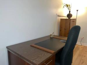 a desk with a chair in a room with a table at Luxury comforts getaway home in Brossard +48 photos