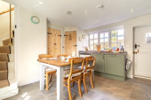 a kitchen with a wooden table and chairs at 2 Bed in Cley oc-2165 in Cley next the Sea +9 photos