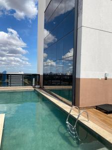 a swimming pool on the roof of a building at Prime Flats in Palmas