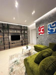 a living room with a couch and a table at DuoNest Gray Loft Studio in Tirana