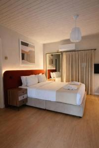 a bedroom with a large bed and a large mirror at Pine View Boutique Hotel Adults Only in Troodos