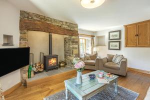 a living room with a fireplace and a table at 3 Bed in Croyde oc-s27761 in Croyde