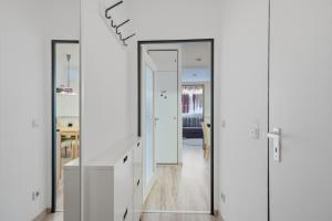 a room with white walls and a hallway with white cabinets at Berolina C 106 in Dahme