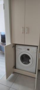 a washer and dryer in a kitchen with a cabinet at Bıyıklı House in Akcaabat