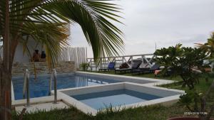 a swimming pool in front of a house at VistamarGrau in Caleta Grau